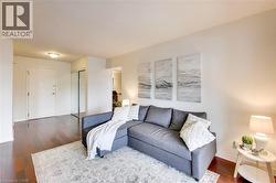 Living area with hardwood / wood-style floors and baseboards - 