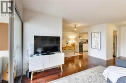 Living room with hardwood / wood-style flooring - 