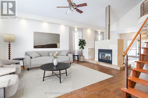 Virtually Staged - 2384 Champlain Road, Tiny, ON - Indoor Photo Showing Living Room With Fireplace
