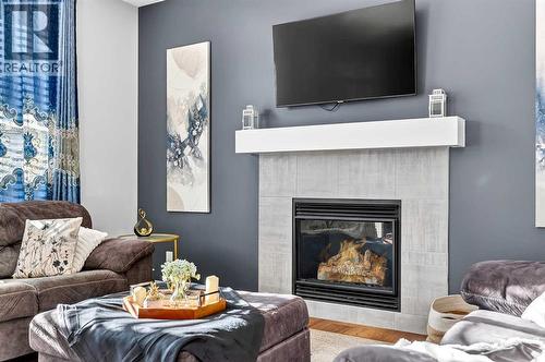 37 Evansfield Manor Nw, Calgary, AB - Indoor Photo Showing Living Room With Fireplace