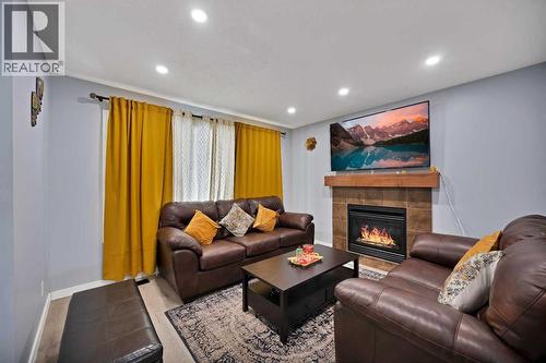 67 Copperstone Circle Se, Calgary, AB - Indoor Photo Showing Living Room With Fireplace