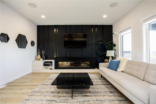 Home is similar, but might not be exact. - 72 Dave'S Cove, West St Paul, MB - Indoor Photo Showing Living Room With Fireplace