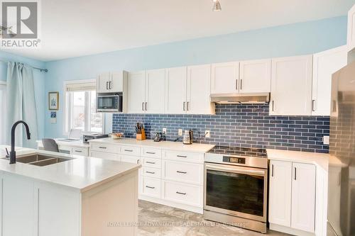 Quartz countertops, striking backsplash ... - 10 Antonio Way, Perth, ON - Indoor Photo Showing Kitchen With Double Sink With Upgraded Kitchen