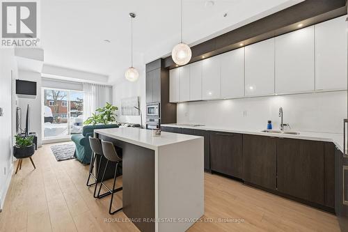 Kitchen Features an Island with Seating for Four - 111 - 1284 Guelph Line, Burlington, ON - Indoor Photo Showing Kitchen With Upgraded Kitchen