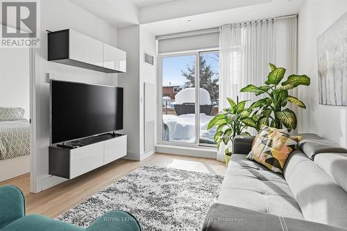 Living Area Opens to Impressive 21' x 12' Terrace - 111 - 1284 Guelph Line, Burlington, ON - Indoor Photo Showing Living Room