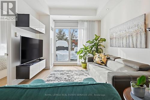 Living Area Opens to Impressive 21' x 12' Terrace - 111 - 1284 Guelph Line, Burlington, ON - Indoor Photo Showing Living Room