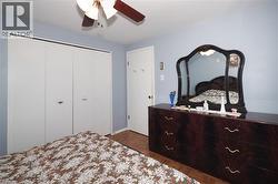 Bedroom with parquet flooring, a closet, and a ceiling fan - 