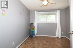 Empty room with parquet floors and ceiling fan - 