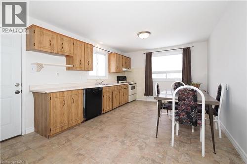Kitchen featuring light countertops, white stove, and black dishwasher - 10 Balfour Crescent, Kitchener, ON - Indoor