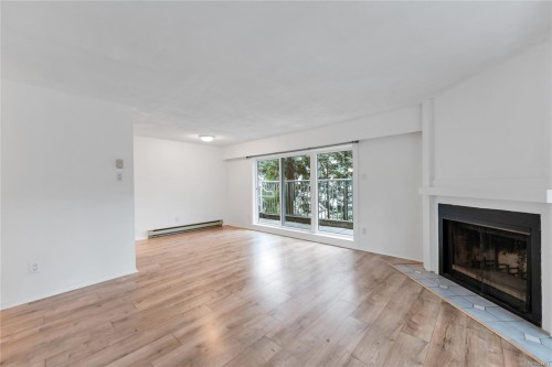 105-3277 Quadra St, Saanich, BC - Indoor Photo Showing Living Room With Fireplace