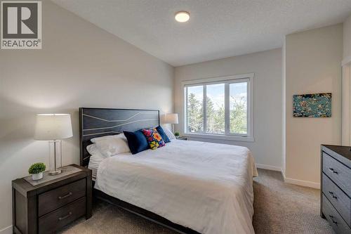Upper level primary bedroom - 614 Greenbriar Common Nw, Calgary, AB - Indoor Photo Showing Bedroom