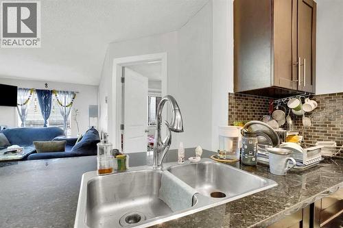 411, 15 Saddlestone Way Ne, Calgary, AB - Indoor Photo Showing Kitchen With Double Sink