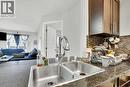 411, 15 Saddlestone Way Ne, Calgary, AB  - Indoor Photo Showing Kitchen With Double Sink 
