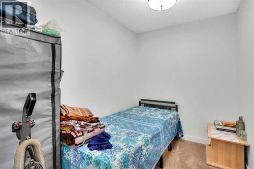 DEN - 411, 15 Saddlestone Way Ne, Calgary, AB - Indoor Photo Showing Bedroom