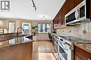 30 Tuscarora Way Nw, Calgary, AB  - Indoor Photo Showing Kitchen With Double Sink With Upgraded Kitchen 