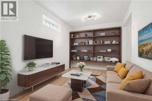 Living room with light wood-style flooring and rail lighting - 28 Grove Street, Hamilton, ON - Indoor Photo Showing Living Room