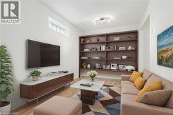 Living room with light wood-style flooring and rail lighting - 