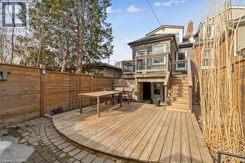 Deck with stairway, a fenced backyard, and outdoor dining space - 28 Grove Street, Hamilton, ON - Outdoor With Deck Patio Veranda