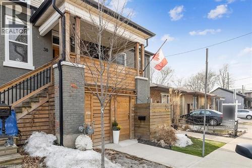 View of side of home featuring brick siding and stairway - 28 Grove Street, Hamilton, ON - Outdoor
