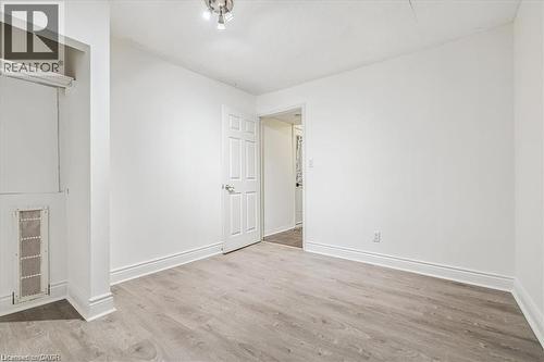 Unfurnished bedroom featuring light wood-style floors and baseboards - 28 Grove Street, Hamilton, ON - Indoor Photo Showing Other Room