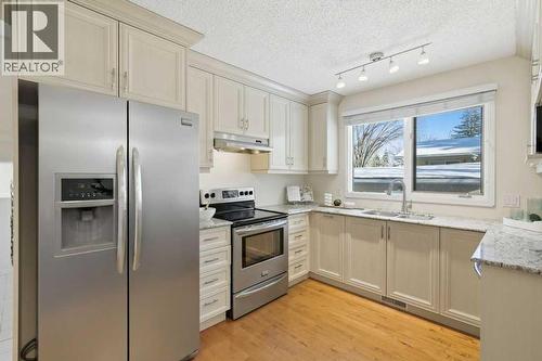 3703 Valdes Place Nw, Calgary, AB - Indoor Photo Showing Kitchen With Stainless Steel Kitchen With Double Sink