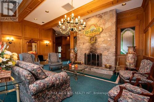 408 - 50 Rivermill Boulevard, Kawartha Lakes (Lindsay), ON - Indoor Photo Showing Living Room With Fireplace