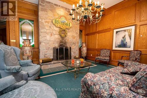 408 - 50 Rivermill Boulevard, Kawartha Lakes (Lindsay), ON - Indoor Photo Showing Living Room With Fireplace