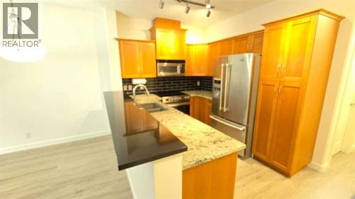 201, 10 Discovery Ridge Close Sw, Calgary, AB - Indoor Photo Showing Kitchen With Stainless Steel Kitchen