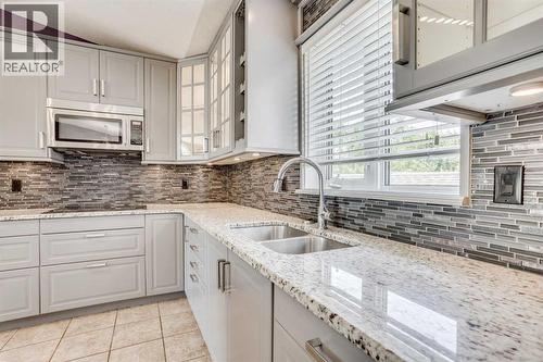 117 Cheecham Court, Anzac, AB - Indoor Photo Showing Kitchen With Double Sink With Upgraded Kitchen