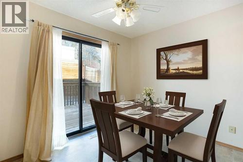 Virtually Staged - 8, 118 Strathcona Road Sw, Calgary, AB - Indoor Photo Showing Dining Room
