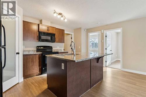4102, 2781 Chinook Winds Drive Sw, Airdrie, AB - Indoor Photo Showing Kitchen With Double Sink