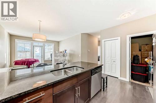 312, 48 Panatella Road Nw, Calgary, AB - Indoor Photo Showing Kitchen With Double Sink