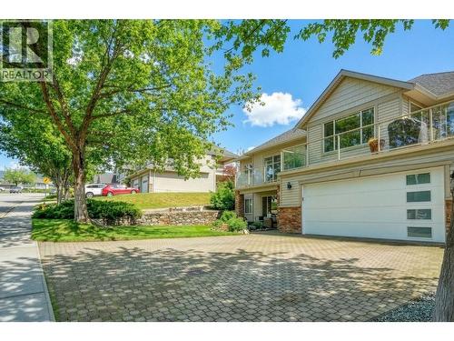 Exterior landscaping has been digitally enhanced to reflect summer conditions. Photos were taken during the winter season. - 867 Steele Road, Kelowna, BC - Outdoor