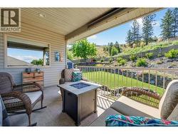 Patio off of the kitchen overlooking the backyard. Exterior landscaping has been digitally enhanced to reflect summer conditions. Photos were taken during the winter season. - 