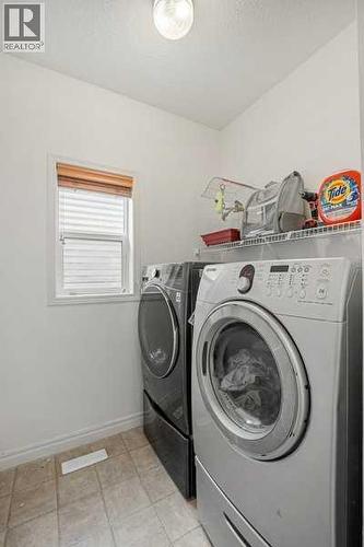 Laundry room - 345 Prestwick Terrace Se, Calgary, AB - Indoor Photo Showing Laundry Room