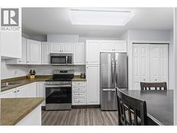 Walk-through Kitchen with stainless steel appliances and room for a dining table - 