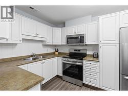 Walk-through Kitchen with stainless steel appliances - 