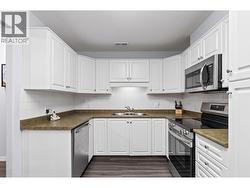 Walk-through Kitchen with stainless steel appliances - 