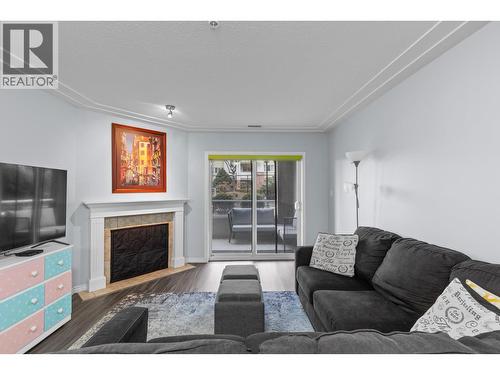 Living Room with Sliding doors to outdoor living space - 1966 Durnin Road Unit# 105, Kelowna, BC - Indoor Photo Showing Living Room With Fireplace