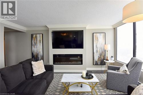 75 Queen Street N Unit# 1707, Hamilton, ON - Indoor Photo Showing Living Room With Fireplace