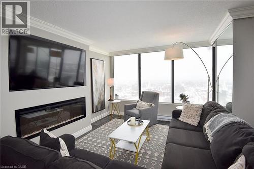 75 Queen Street N Unit# 1707, Hamilton, ON - Indoor Photo Showing Living Room With Fireplace