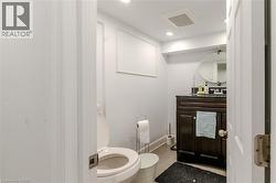 Half bath with tile patterned flooring, vanity, and recessed lighting - 