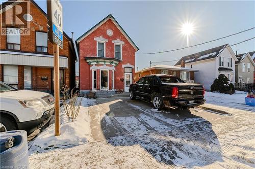 View of front facade featuring brick siding and a residential view - 126 Tisdale Street N, Hamilton, ON - Outdoor