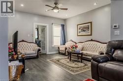 Living area featuring wood finished floors, recessed lighting, and ceiling fan - 
