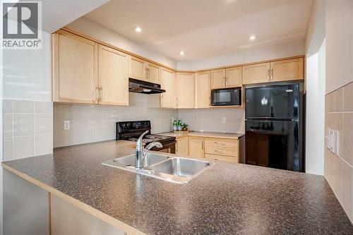 3005 Windsong Boulevard Sw, Airdrie, AB - Indoor Photo Showing Kitchen With Double Sink