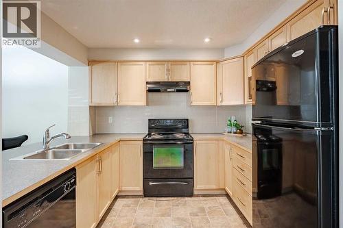 3005 Windsong Boulevard Sw, Airdrie, AB - Indoor Photo Showing Kitchen With Double Sink