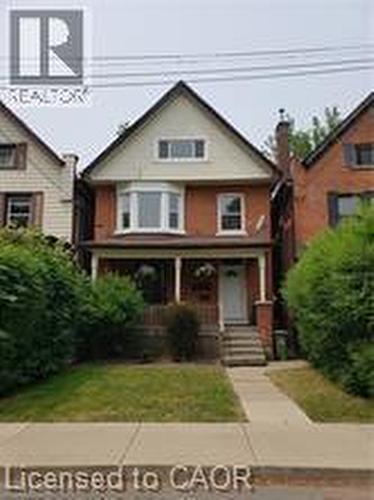 Bungalow-style house featuring a porch and a front yard - 180 Emerald Street S, Hamilton, ON - Outdoor With Facade