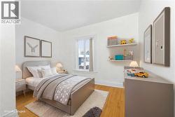 Bedroom with light wood-type flooring and baseboards - 