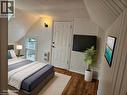 Bedroom with lofted ceiling, dark wood-type flooring, and heating unit - 180 Emerald Street S, Hamilton, ON  - Indoor Photo Showing Bedroom 