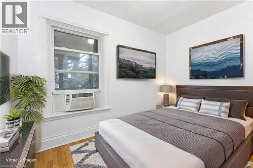 Bedroom featuring light wood finished floors and baseboards - 180 Emerald Street S, Hamilton, ON - Indoor Photo Showing Bedroom